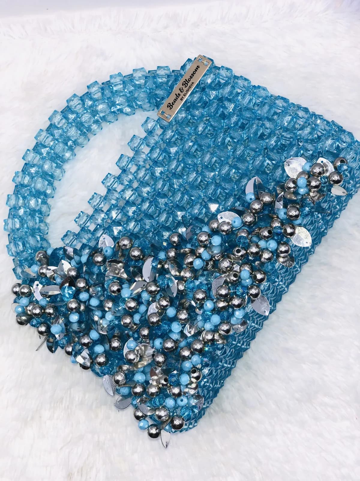 AYANFẸ́: Sequinned beaded evening bag in blue and silver or black and gold, hand-strung in Black + Gold