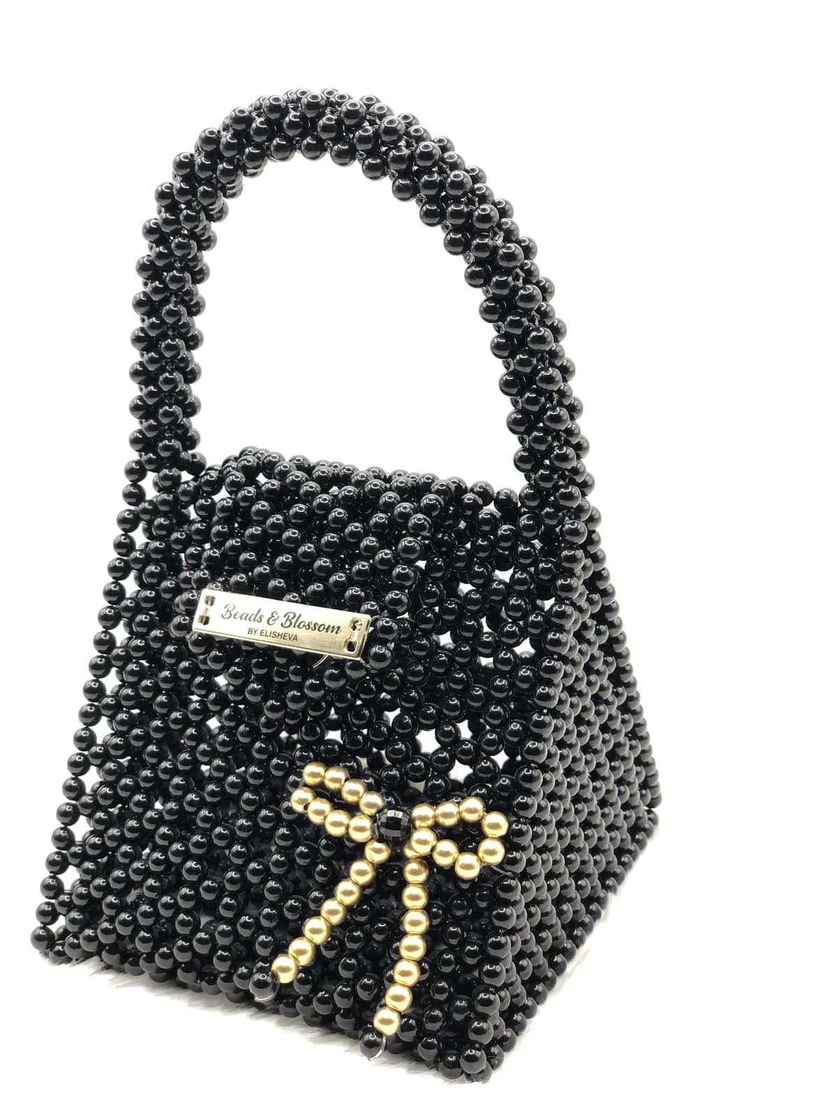 ÀṢẸ: Black bag with a gold bow, hand-strung in Onyx + Harmattan Gold