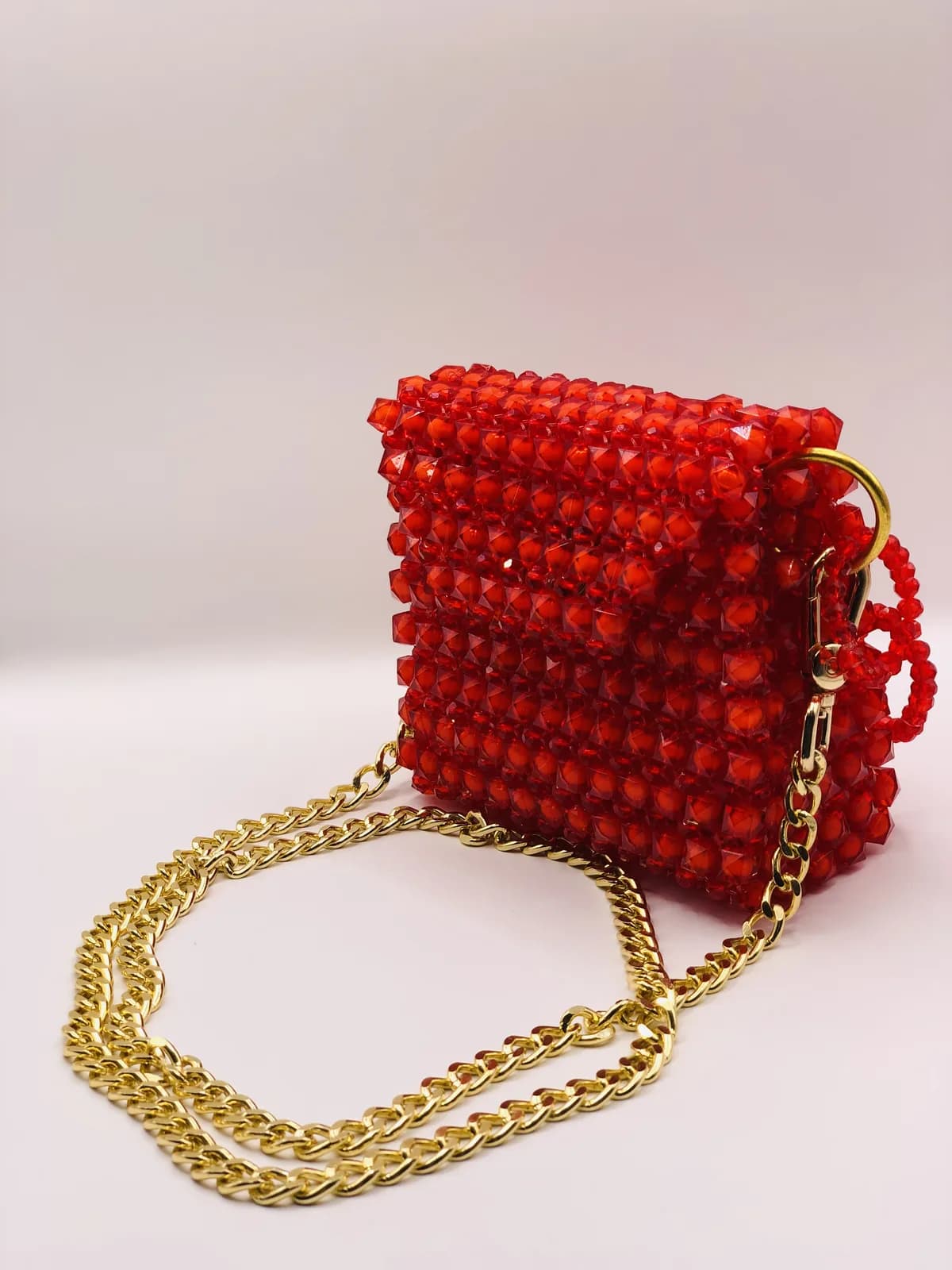 ÀRÁ: Red crossbody on a gold chain, hand-strung in Clay + Gold
