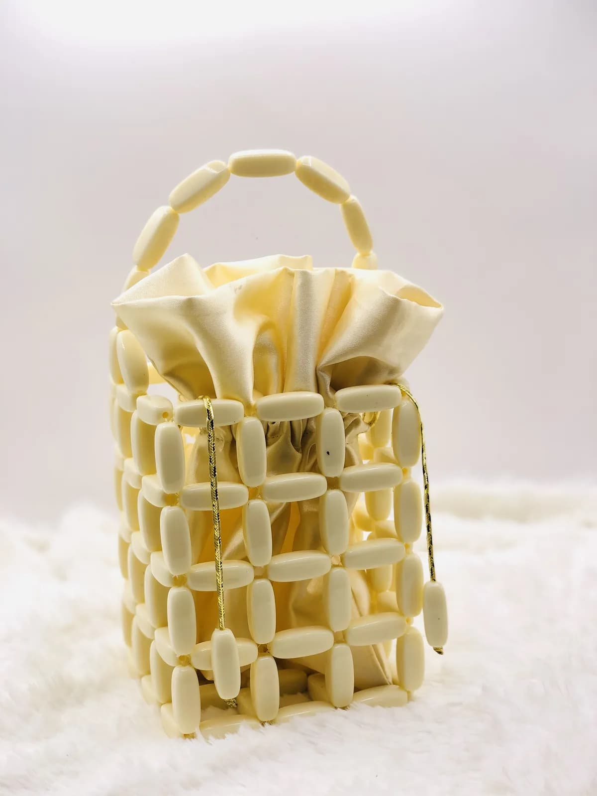 ÌYÀNÚ: Ivory cage bucket, hand-strung in Pearl
