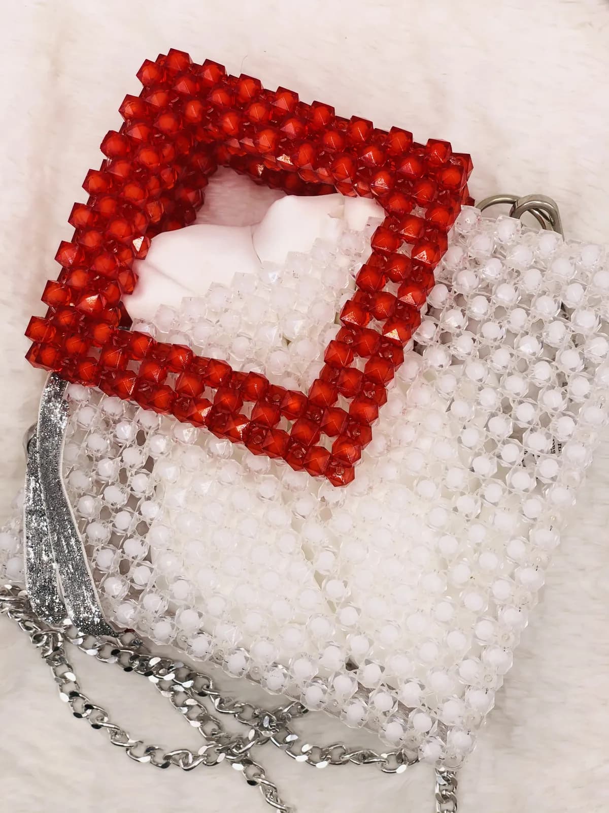 ÌTÀN: Pearl clutch in a red frame, hand-strung in Pearl + Clay