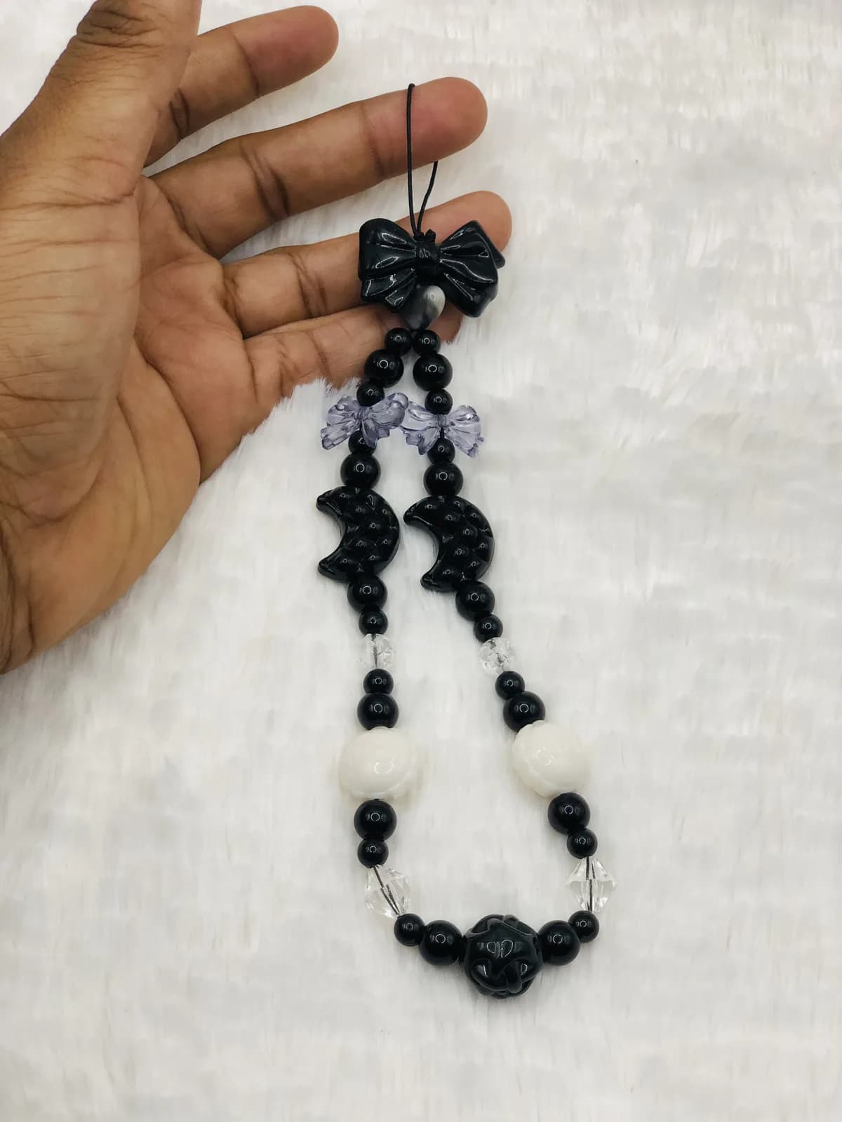 ÒJÌJÍ: Jet phone strap with a bow, hand-strung in Onyx