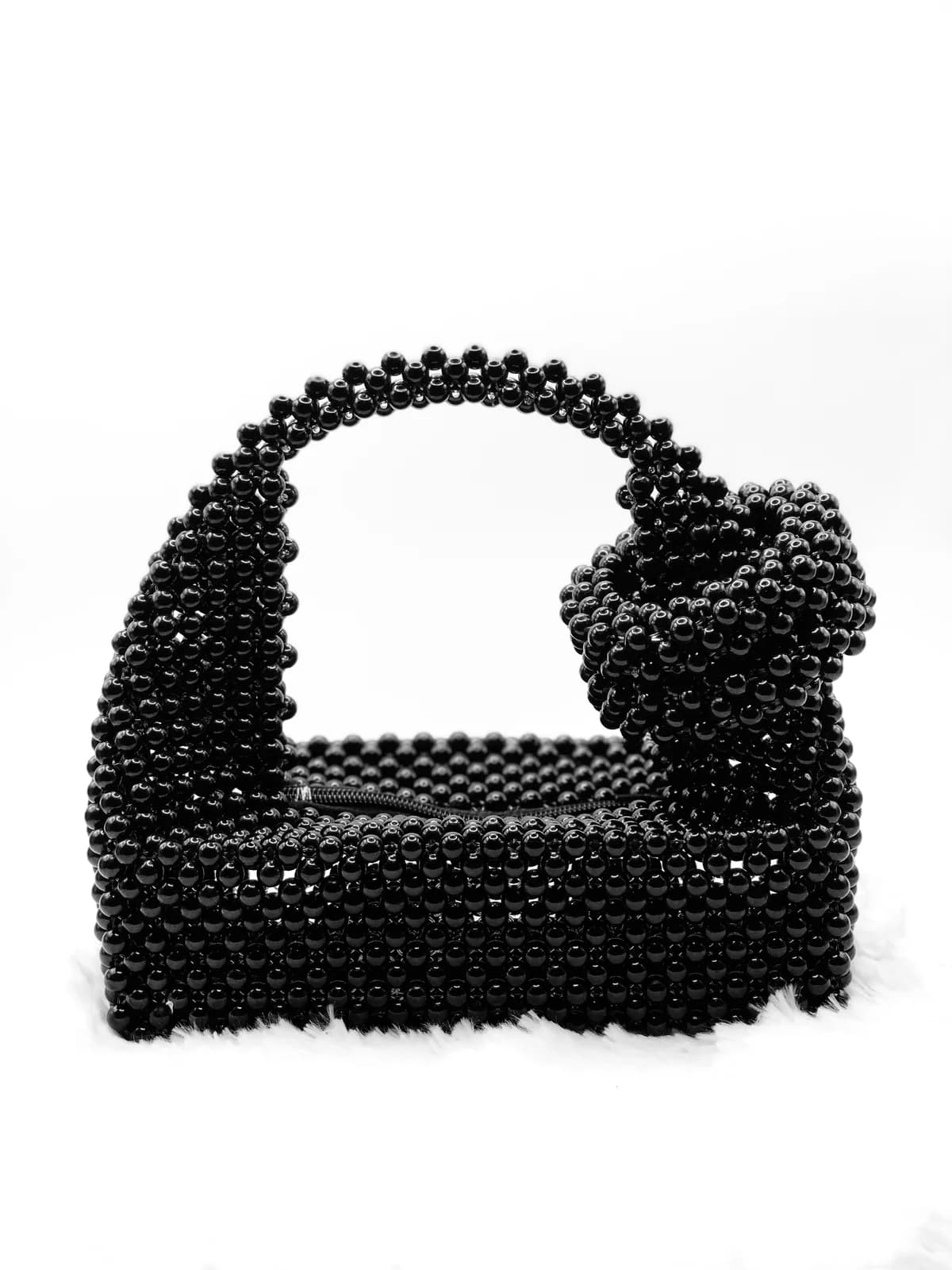 AYANFẸ́: Black bow clutch, hand-strung in Onyx + Jet