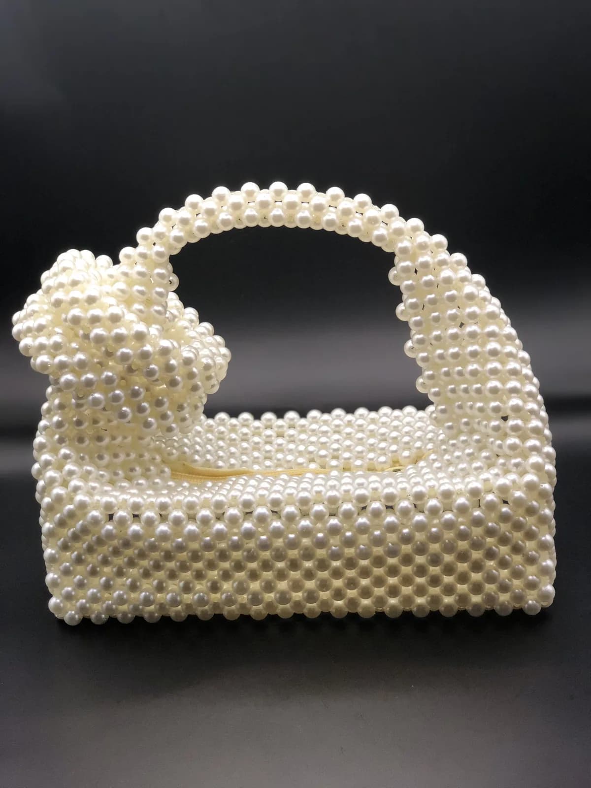 Ivory pearl bag with a beaded bow