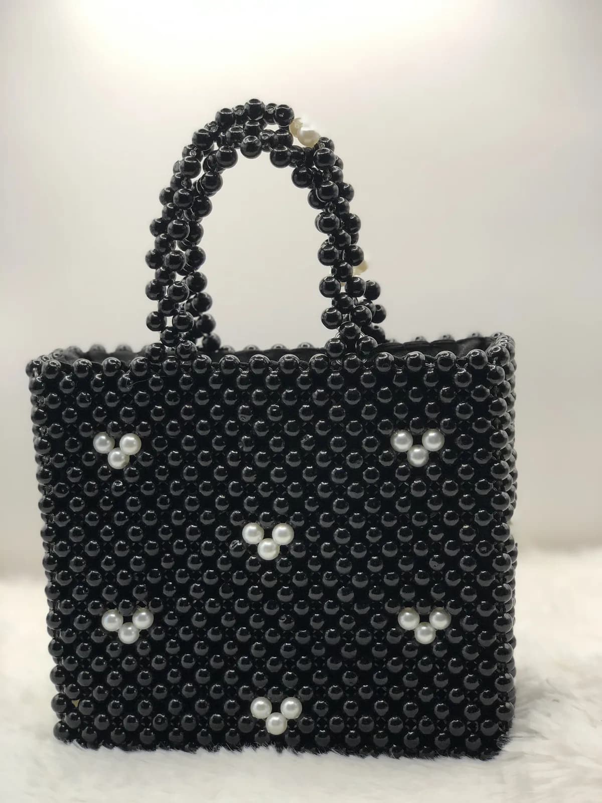 Black beadwork with pearl trios